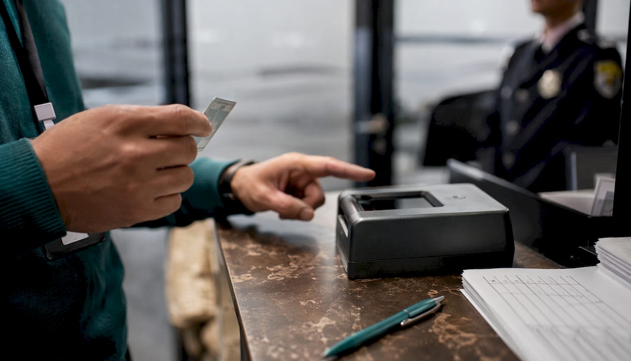 Hands interacting with biometric eKYC hardware