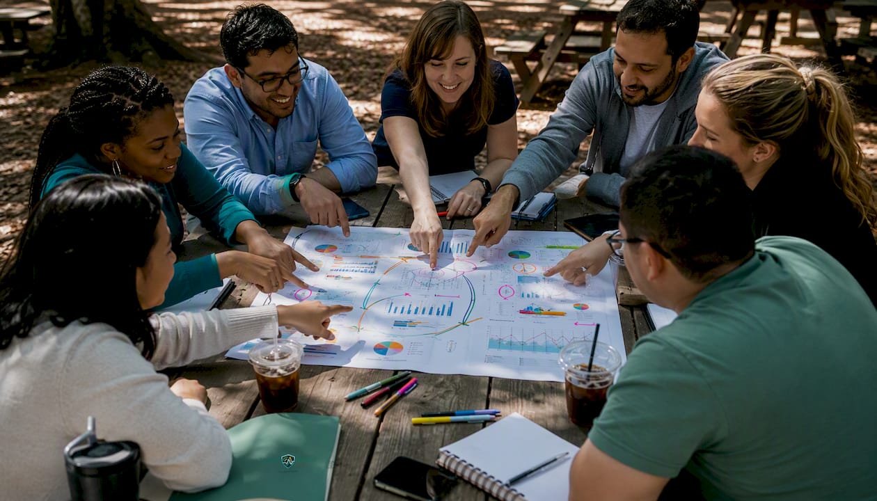 Overhead view of fraud team discussing signals