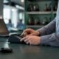 Hands handling authentication device at call center