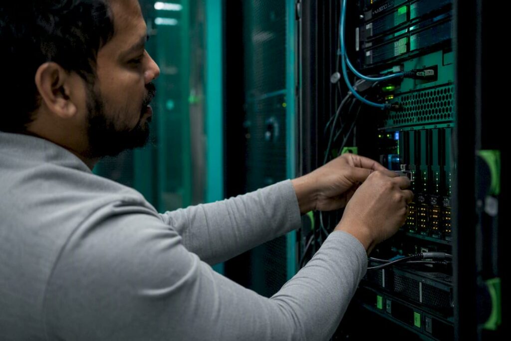 Hands installing components in fintech server rack