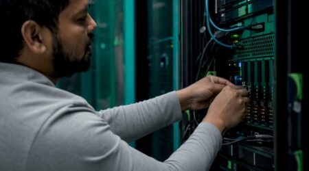 Hands installing components in fintech server rack