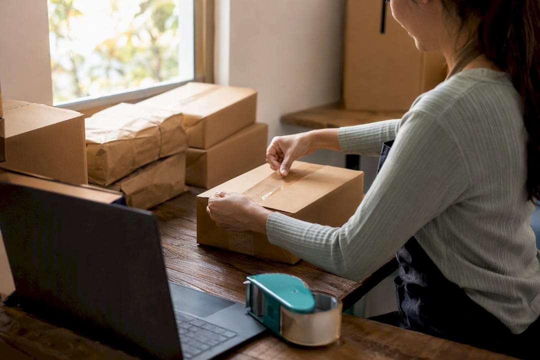 Hands packing box with ID verification token