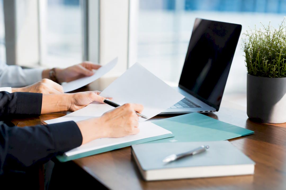 Hands arranging charts for marketing analysis