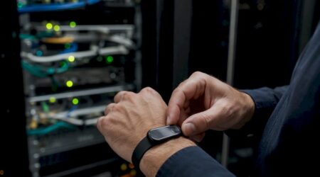 Hands holding hardware security token near server