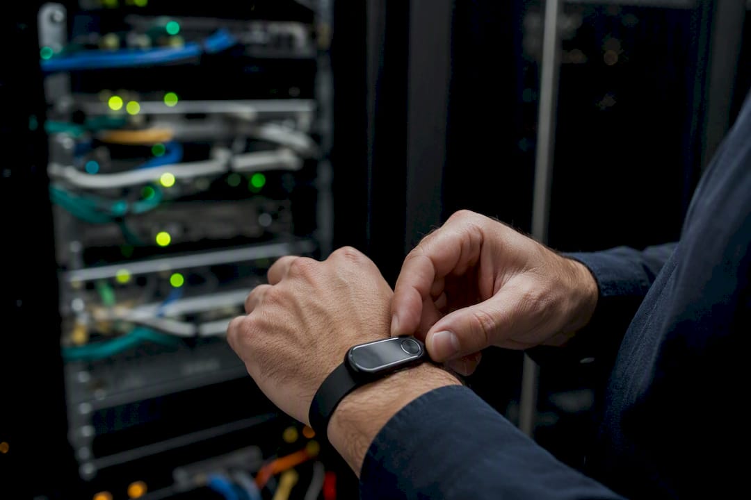 Hands holding hardware security token near server