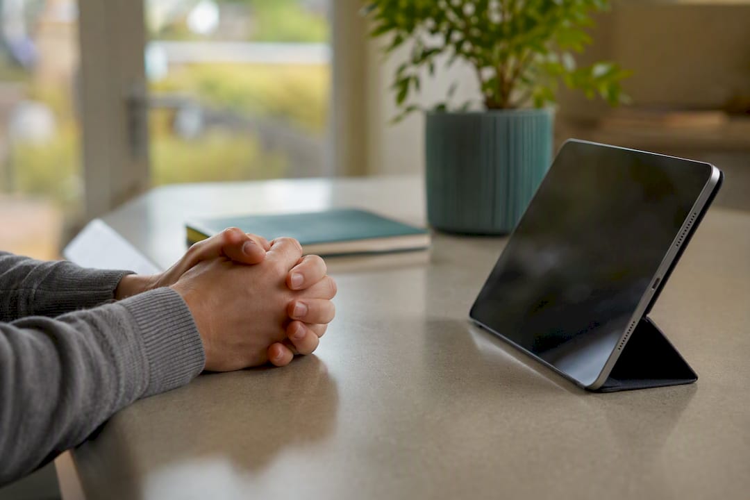 Frustrated user hands on desk near dark screen