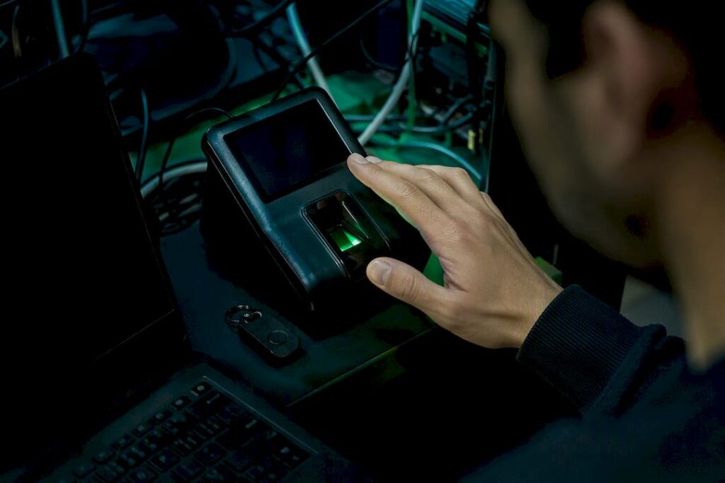 Hand using biometric scanner in secure lab