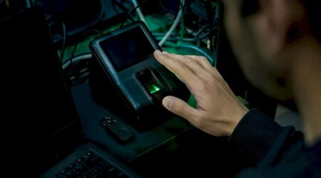 Hand using biometric scanner in secure lab