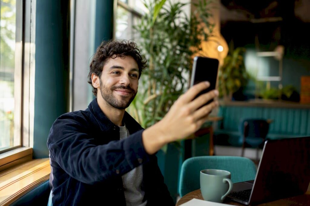 Hand holding phone ready for selfie verification