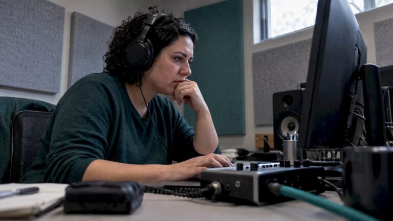 Analyst reviewing recorded call for voice cloning