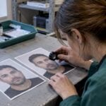 Forensic analyst comparing face morph photographs