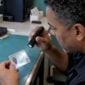 Examiner tilts a driver's license under light