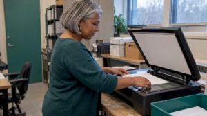 Staff member prepares a document for scanning